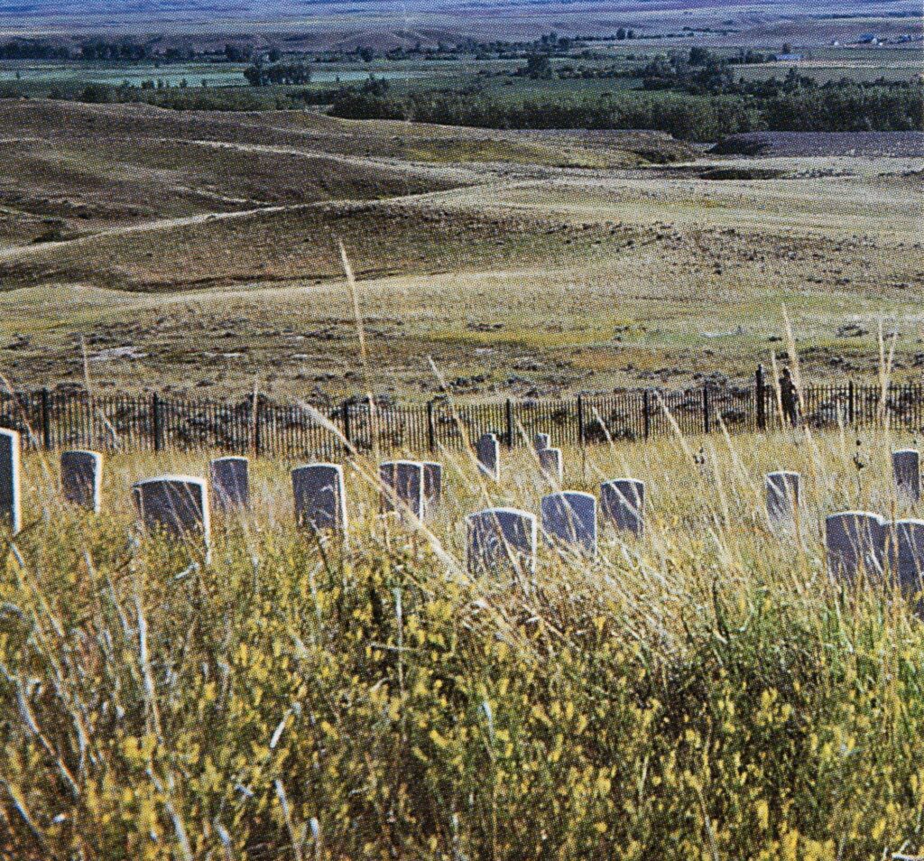 Little Bighorn Battlefield-Cementery. A cemetery on top of a hill, surrounded by yellow grass and a short black fence